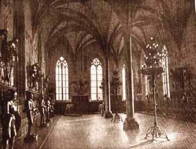 A Medieval hall with armor and candles